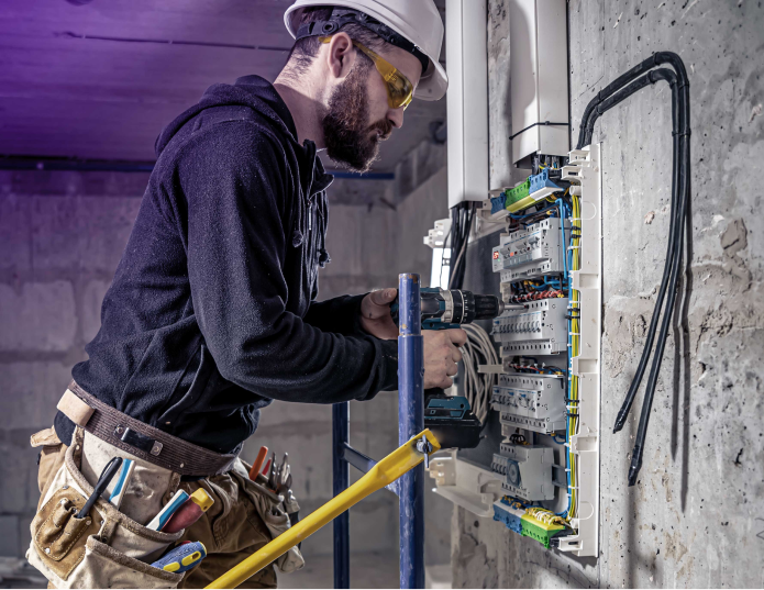 Technician screwing interrupter to the board